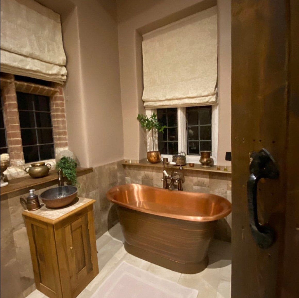 Traditional luxury bathroom installation in Norfolk with copper freestanding bath and vanity basin