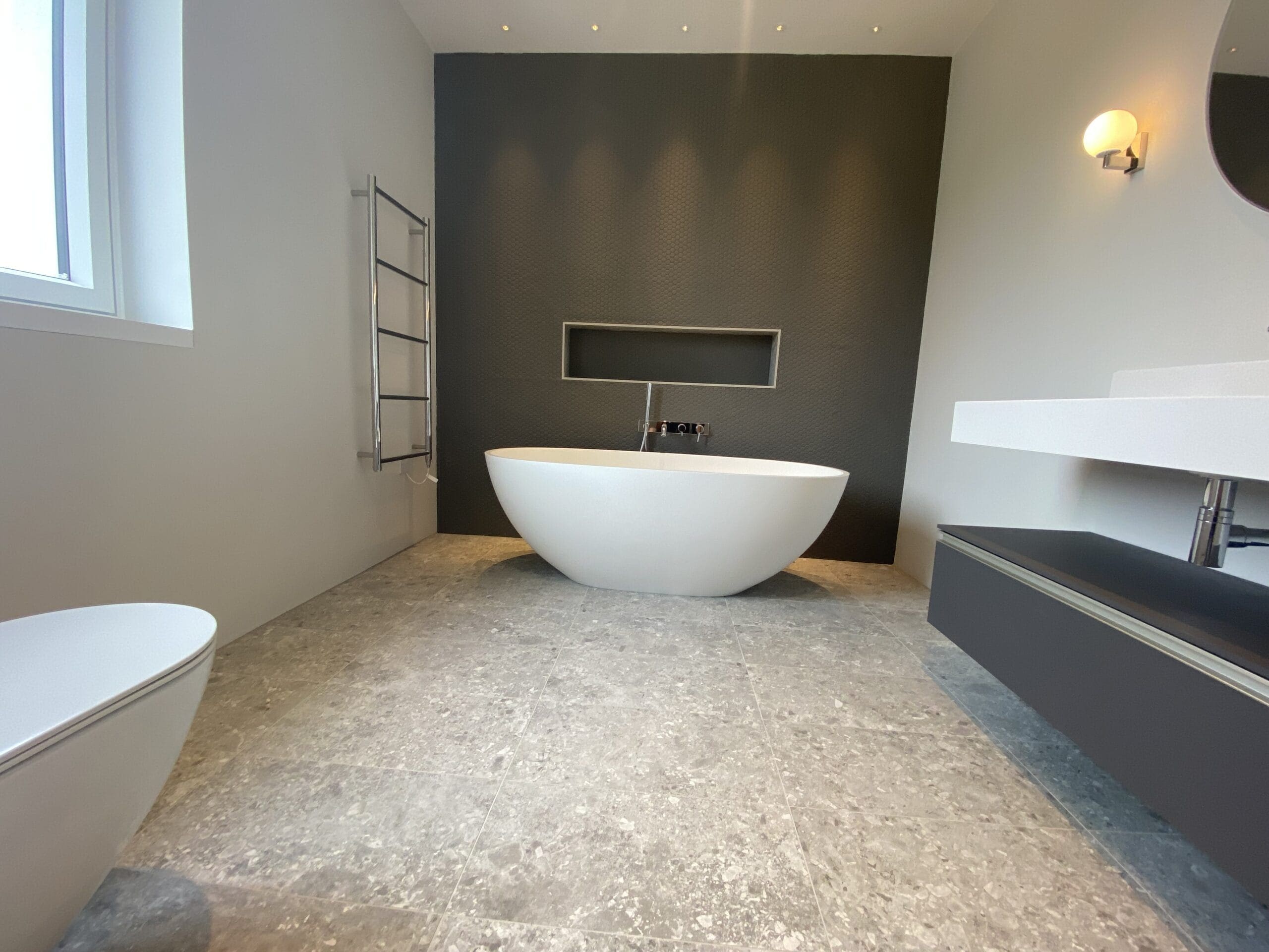 Plumber assessing shower pressure and bathroom layout in a Hunstanton bungalow