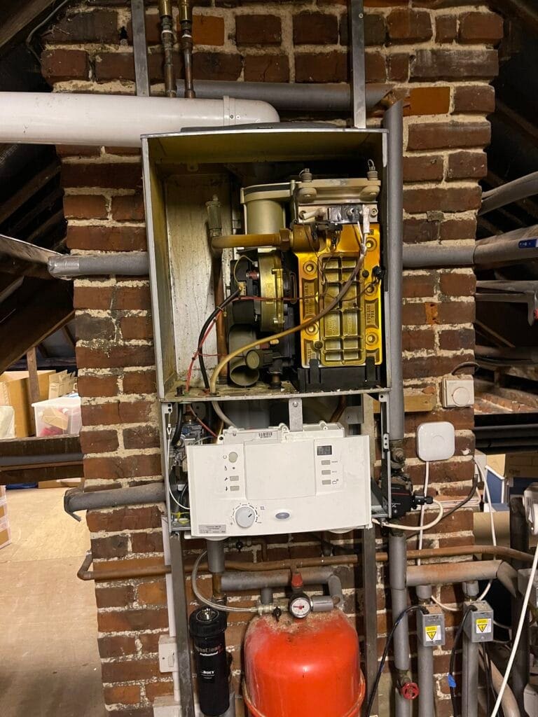 Gas Safe boiler service with casing removed, internal components exposed and heating system parts inspected
