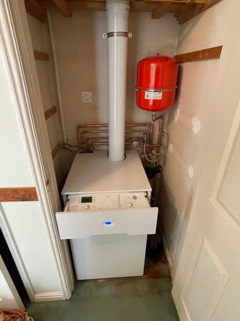 Gas, Oil and LPG Boiler Support in Aylsham | Allstar Systems Ltd Heating engineer checking gas oil and LPG boiler options for an Aylsham home