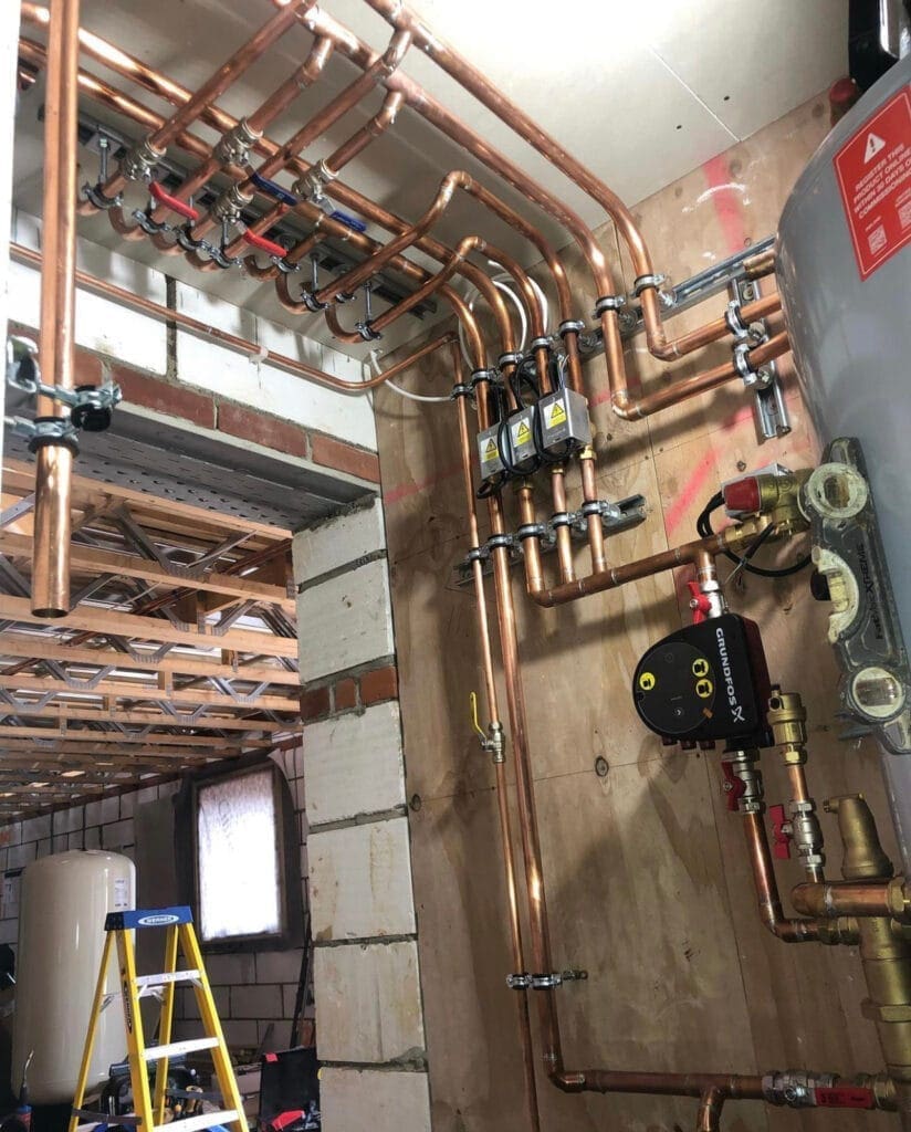 Heating engineer checking smart thermostat and heating controls in a Downham Market home